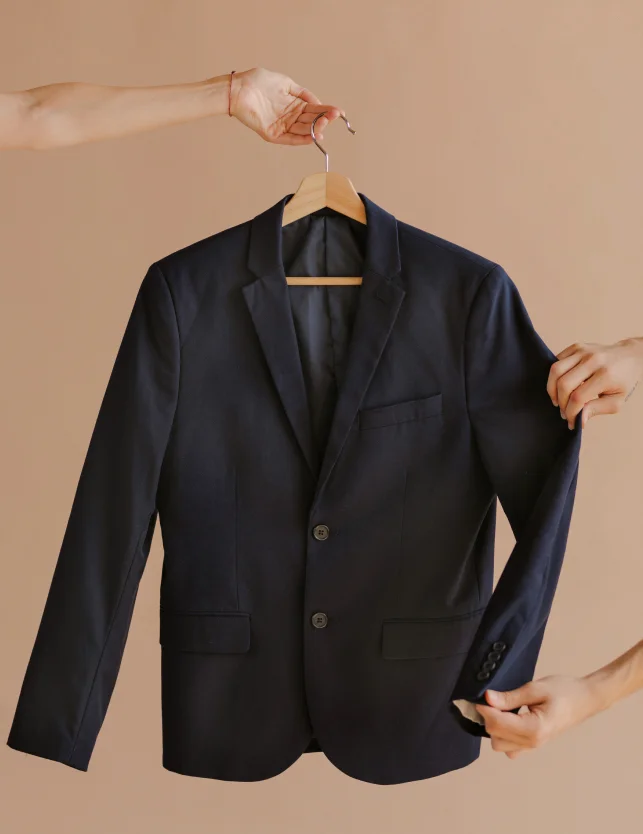 Black blazer displayed on a hanger