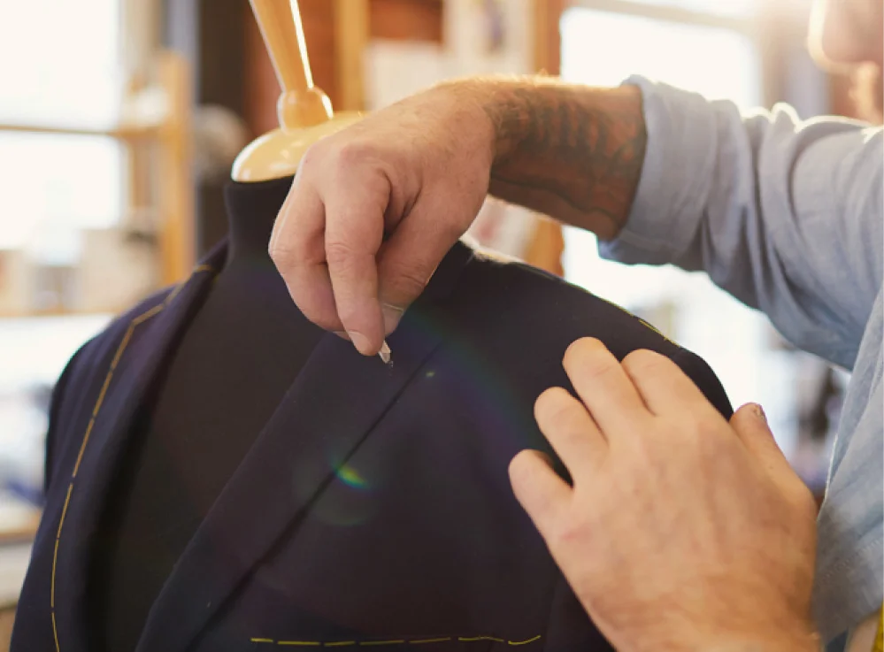 Measuring tape draped over a tailored jacket